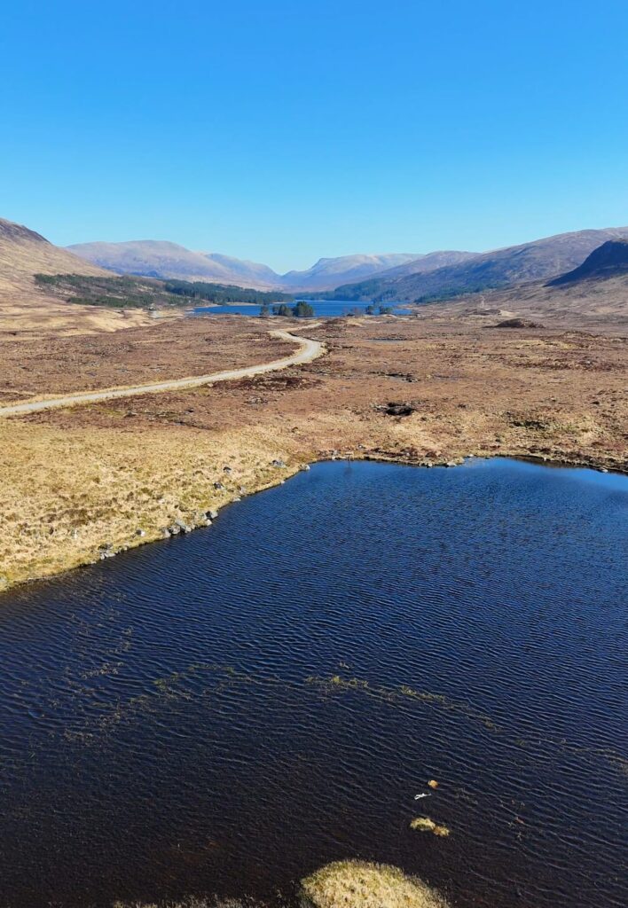 Die weiten Landschaften der schottischen Highlands mit Bergen, Seen und Panoramastraßen